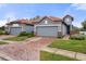 Two-story home with gray exterior, tile roof, and brick paver driveway at 4108 Solamor St, Lakeland, FL 33810