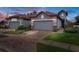 Two-story home with gray exterior, tile roof, and brick paver driveway at 4108 Solamor St, Lakeland, FL 33810