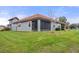 House exterior showcasing a tile roof and lush lawn at 4108 Solamor St, Lakeland, FL 33810