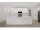 Modern kitchen with white cabinets and island at 4108 Solamor St, Lakeland, FL 33810