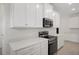 Modern kitchen with white cabinets and stainless steel appliances at 4108 Solamor St, Lakeland, FL 33810