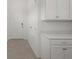 White cabinets and countertop in a laundry room at 4108 Solamor St, Lakeland, FL 33810