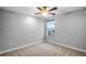 Well-lit bedroom with carpet flooring and a ceiling fan at 4185 Shearwater St, Lakeland, FL 33811