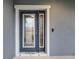 Modern front door with glass panels and a doorbell at 4185 Shearwater St, Lakeland, FL 33811