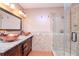 Elegant bathroom with copper sinks, granite countertop, and a large shower at 4225 Shadow Wood Ct, Winter Haven, FL 33880