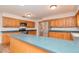 Spacious kitchen featuring wood cabinets, stainless steel appliances, and a breakfast bar at 4225 Shadow Wood Ct, Winter Haven, FL 33880