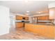 Bright kitchen with wood cabinets, stainless steel appliances, and a large island at 4225 Shadow Wood Ct, Winter Haven, FL 33880