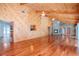 Large living area with hardwood floors, wood walls, stone fireplace and high ceilings at 4225 Shadow Wood Ct, Winter Haven, FL 33880