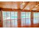 Living room with hardwood floors, high ceilings, and sliding doors leading to the pool at 4225 Shadow Wood Ct, Winter Haven, FL 33880