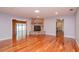 Hardwood floors and a stone fireplace feature in this open living room at 4225 Shadow Wood Ct, Winter Haven, FL 33880