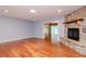 Living room features hardwood floors and stone fireplace at 4225 Shadow Wood Ct, Winter Haven, FL 33880