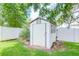 White storage shed in the backyard at 4225 Shadow Wood Ct, Winter Haven, FL 33880