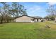 Large backyard with grassy area, fire pit, and home's back exterior at 4312 Glenview Dr, Lakeland, FL 33810