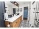 Stylish bathroom featuring double sinks, a large mirror, and patterned floor tiles at 4312 Glenview Dr, Lakeland, FL 33810