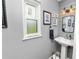 Small bathroom with pedestal sink, gray walls, and shiplap accents at 4312 Glenview Dr, Lakeland, FL 33810