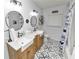 Charming bathroom with farmhouse sinks, patterned floor, and a shower/tub combo at 4312 Glenview Dr, Lakeland, FL 33810