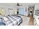 Main bedroom with king-size bed, light blue closet doors, and hardwood flooring at 4312 Glenview Dr, Lakeland, FL 33810