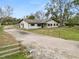 House with a gravel driveway and wooden fence at 4312 Glenview Dr, Lakeland, FL 33810