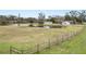 Wooden fence surrounding a property with a pond at 4312 Glenview Dr, Lakeland, FL 33810