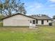 House back view, showing a white building with a small patio and yard at 4312 Glenview Dr, Lakeland, FL 33810