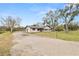 House front view, showcasing a gravel driveway and landscaping at 4312 Glenview Dr, Lakeland, FL 33810