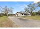 Side view of a house, showcasing a gravel driveway and landscaping at 4312 Glenview Dr, Lakeland, FL 33810