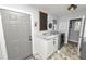 Laundry room with white cabinets, granite countertops, and a convenient door at 4312 Glenview Dr, Lakeland, FL 33810