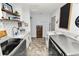 Bright laundry room with white cabinets, granite countertops, and a laundry sink at 4312 Glenview Dr, Lakeland, FL 33810