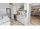 Laundry room with white shaker cabinets, granite countertops, and laundry appliances at 4312 Glenview Dr, Lakeland, FL 33810