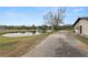 Property features a pond and long gravel driveway at 4312 Glenview Dr, Lakeland, FL 33810