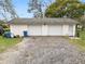 Two-car garage with gravel driveway and additional storage space at 4312 Glenview Dr, Lakeland, FL 33810