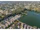 Aerial view of a lakeside community with lush trees and picturesque waterfront homes at 4481 Pebble Pointe Dr, Lakeland, FL 33813