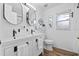 Bright bathroom featuring a dual vanity, wood floors, and modern fixtures and finishes at 4481 Pebble Pointe Dr, Lakeland, FL 33813