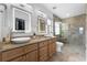 Bright bathroom featuring double sinks, granite countertop, and a large glass walk-in shower at 4481 Pebble Pointe Dr, Lakeland, FL 33813