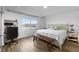 Bright bedroom with a large window overlooking the water and wood-look tile flooring at 4481 Pebble Pointe Dr, Lakeland, FL 33813