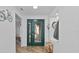 Bright entryway with green door and wood floor at 4481 Pebble Pointe Dr, Lakeland, FL 33813