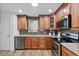 Well-equipped kitchen with wood cabinets and granite countertops at 4481 Pebble Pointe Dr, Lakeland, FL 33813