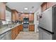 Updated kitchen featuring stainless steel appliances, wood cabinets and modern tile flooring at 4481 Pebble Pointe Dr, Lakeland, FL 33813