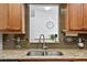 Kitchen sink with granite countertop and stylish backsplash at 4481 Pebble Pointe Dr, Lakeland, FL 33813