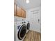 Bright laundry room, featuring washer, dryer, and ample cabinetry at 4481 Pebble Pointe Dr, Lakeland, FL 33813