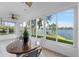 Sunroom boasts water views and a table with chairs at 4481 Pebble Pointe Dr, Lakeland, FL 33813