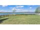 Large backyard with lake view, grassy area, and a black fence at 4512 Brookshire Pl, Lake Wales, FL 33898