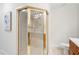 Bright bathroom shows a walk-in shower with gold framing, and a toilet and sink beside it at 4718 Valley Hill Ct, Lakeland, FL 33813