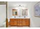 Bathroom showcasing a double vanity with wood cabinets, and a walk-in shower with glass door at 4718 Valley Hill Ct, Lakeland, FL 33813