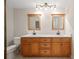 Double vanity bathroom with wood cabinets and a large shower at 4718 Valley Hill Ct, Lakeland, FL 33813