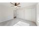 Neutral bedroom features soft carpet, a ceiling fan with light, and two closets, providing ample storage at 4718 Valley Hill Ct, Lakeland, FL 33813