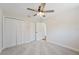 Bedroom features neutral carpet, a ceiling fan with light, and two closets, offering generous storage space at 4718 Valley Hill Ct, Lakeland, FL 33813
