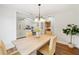 Cozy dining room with neutral tones, modern lighting, and open access to the living room and kitchen at 4718 Valley Hill Ct, Lakeland, FL 33813