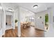 Light and airy dining room featuring wood floors, modern lighting, and access to the front entrance at 4718 Valley Hill Ct, Lakeland, FL 33813