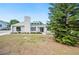 Charming single-story home with a light-colored exterior, a black front door, and tidy landscaping at 4718 Valley Hill Ct, Lakeland, FL 33813